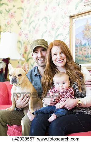 Stock Photo - Portrait of family with one child (2-5 months) and French bulldog. Fotosearch