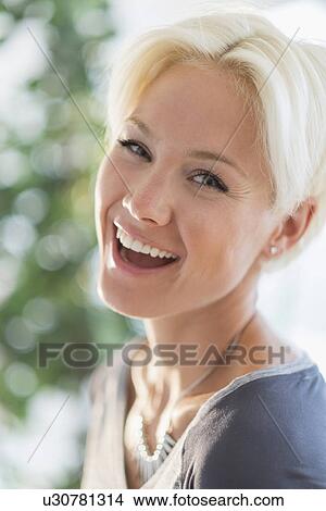 Portrait of happy blonde woman laughing View Large Photo Image Picture - Portrait of happy blonde woman laughing. Fotosearch