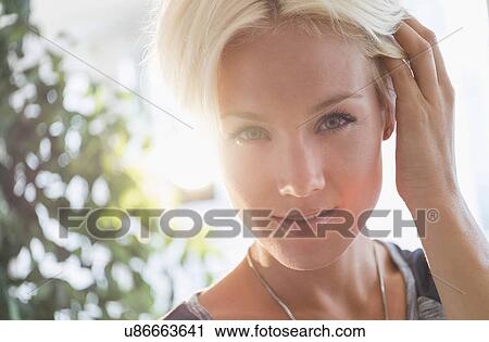 Stock Image - Portrait of happy blonde woman smiling. Fotosearch
