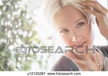 Portrait of happy blonde woman smiling View Large Photo Image Stock Photo - Portrait of happy blonde woman smiling. Fotosearch