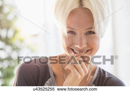 Portrait of happy blonde woman smiling View Large Photo Image Stock Photography - Portrait of happy blonde woman smiling. Fotosearch