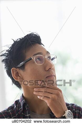 Stock Image - Portrait of man contemplating. Fotosearch