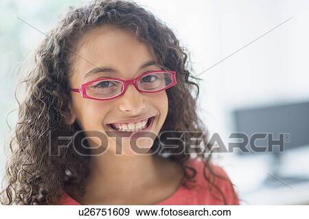 Stock Photo - Portrait of schoolgirl (8-9) wearing pink eyeglasses. Fotosearch