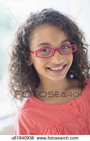 Portrait of schoolgirl (8-9) wearing pink eyeglasses View Large Photo Image Stock Photo - Portrait of schoolgirl (8-9) wearing pink eyeglasses. Fotosearch
