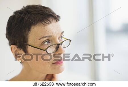 Portrait of senior woman wearing eyeglasses View Large Photo Image Stock Image - Portrait of senior woman wearing eyeglasses. Fotosearch
