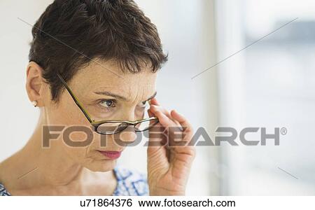 Portrait of senior woman wearing eyeglasses View Large Photo Image Stock Photograph - Portrait of senior woman wearing eyeglasses. Fotosearch