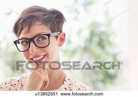 Portrait of smiling woman wearing eyeglasses View Large Photo Image Stock Image - Portrait of smiling woman wearing eyeglasses. Fotosearch