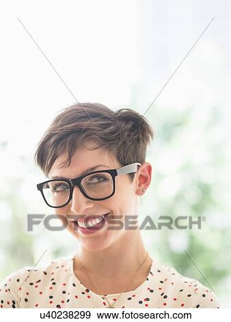 Portrait of smiling woman wearing eyeglasses View Large Photo Image Stock Photo - Portrait of smiling woman wearing eyeglasses. Fotosearch