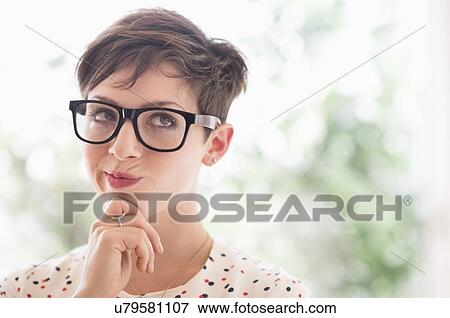 Portrait of smiling woman wearing eyeglasses View Large Photo Image Stock Photo - Portrait of smiling woman wearing eyeglasses. Fotosearch