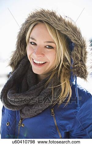 Portrait of smiling young woman in winter coat hood View Large Photo Image Stock Photo - Portrait of smiling young woman in winter coat hood. Fotosearch