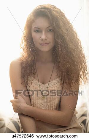Stock Photograph - Portrait of stylish woman in window sill. Fotosearch