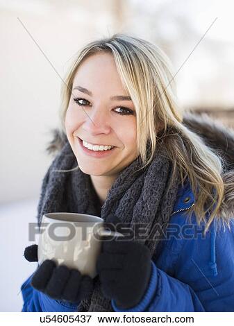 Portrait of woman holding coffee mug outdoors in winter View Large Photo Image Stock Photo - Portrait of woman holding coffee mug outdoors in winter. Fotosearch