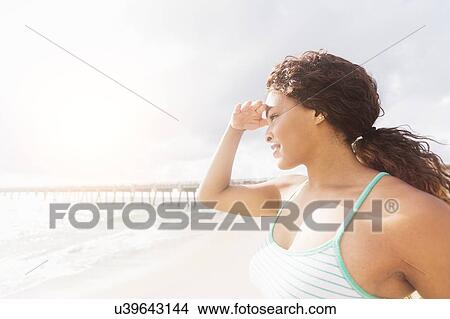 Portrait of woman looking at sea View Large Photo Image Picture - Portrait of woman looking at sea. Fotosearch