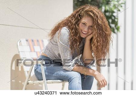 Portrait of woman sitting in deck chair outdoors View Large Photo Image Stock Image - Portrait of woman sitting in deck chair outdoors. Fotosearch