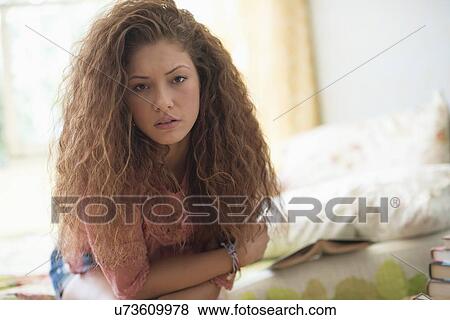 Portrait of woman sitting on bed View Large Photo Image Stock Photo - Portrait of woman sitting on bed. Fotosearch