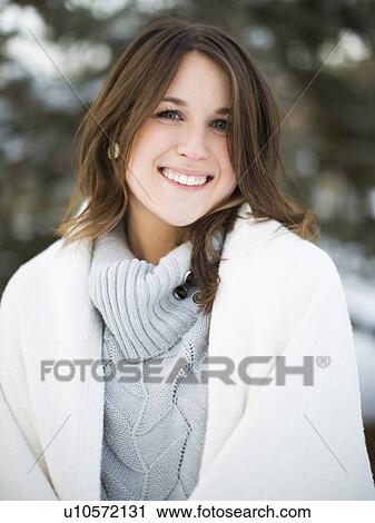 Stock Image - Portrait of woman smiling outdoors. Fotosearch