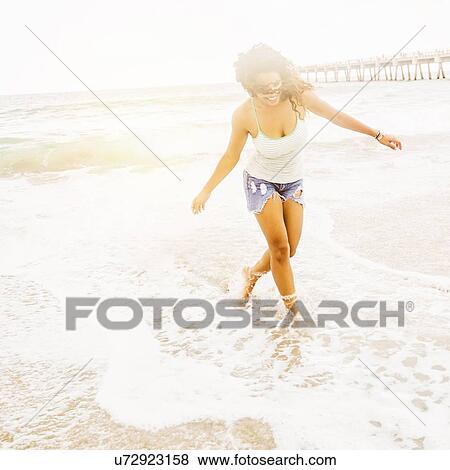 Portrait of woman standing on beach View Large Photo Image Stock Photo - Portrait of woman standing on beach. Fotosearch