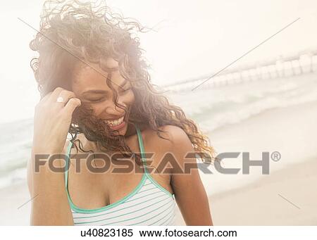 Portrait of woman standing on beach View Large Photo Image Stock Photography - Portrait of woman standing on beach. Fotosearch