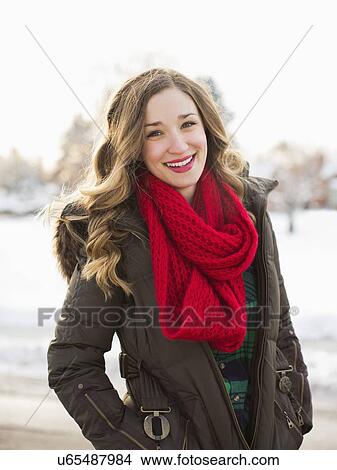 Portrait of woman wearing red scarf smiling outdoors View Large Photo Image Picture - Portrait of woman wearing red scarf smiling outdoors. Fotosearch