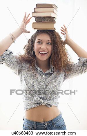 Portrait of woman with books on top of head View Large Photo Image Stock Image - Portrait of woman with books on top of head. Fotosearch