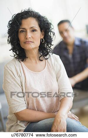 Picture - Portrait of woman with man in background. Fotosearch
