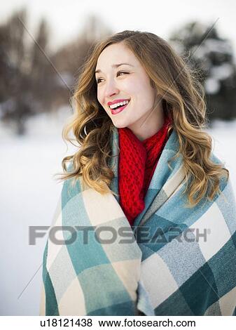 Portrait of woman wrapped in blanket smiling outdoors View Large Photo Image Stock Photo - Portrait of woman wrapped in blanket smiling outdoors. Fotosearch
