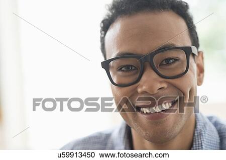 Stock Image - Portrait of young man smiling. Fotosearch