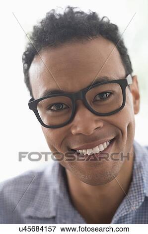 Portrait of young man smiling View Large Photo Image Stock Photo - Portrait of young man smiling. Fotosearch