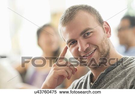 Stock Photography - Portrait of young man smiling. Fotosearch