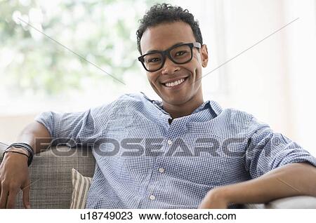 Portrait of young relaxed man smiling View Large Photo Image Stock Image - Portrait of young relaxed man smiling. Fotosearch