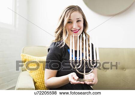 Portrait of young woman holding menorah View Large Photo Image Stock Photo - Portrait of young woman holding menorah. Fotosearch