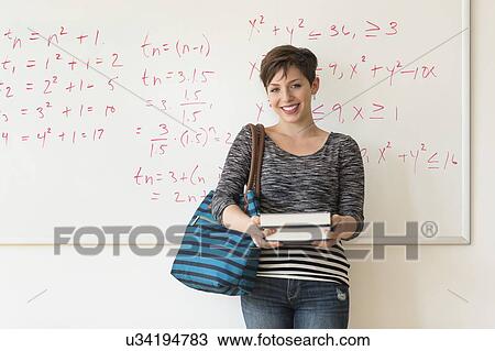 Portrait of young woman in front of whiteboard View Large Photo Image Stock Image - Portrait of young woman in front of whiteboard. Fotosearch