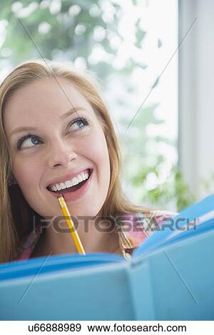 Stock Photo - Portrait of young woman planning. Fotosearch
