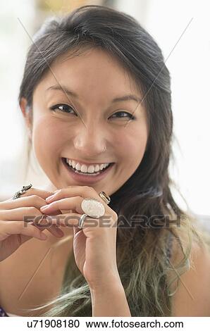 Stock Image - Portrait of young woman smiling. Fotosearch