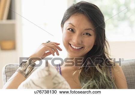 Stock Image - Portrait of young woman smiling. Fotosearch
