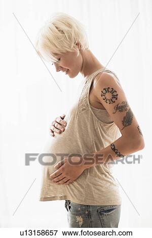 Pregnant woman with hands on stomach View Large Photo Image Stock Photo - Pregnant woman with hands on stomach. Fotosearch