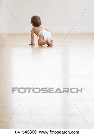 Rear view of baby girl (18-23 months) on hardwood floor View Large Photo Image Stock Image - Rear view of baby girl (18-23 months) on hardwood floor. Fotosearch