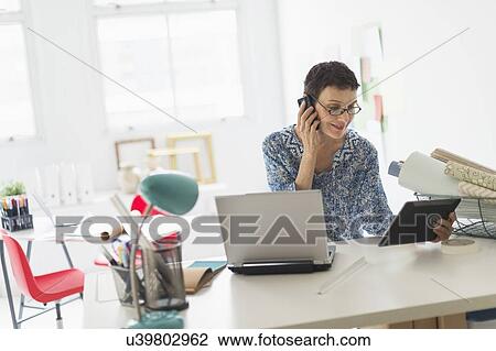 Senior business woman using cell phone and tablet pc in office View Large Photo Image Stock Image - Senior business woman using cell phone and tablet pc in office. Fotosearch