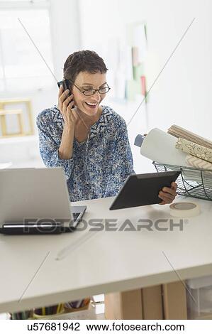 Senior business woman using cell phone and tablet pc in office View Large Photo Image Stock Image - Senior business woman using cell phone and tablet pc in office. Fotosearch