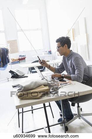 Stock Photo - Side view of man working in studio. Fotosearch