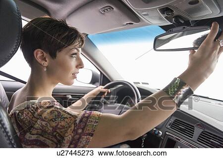 Side view of woman driving car View Large Photo Image Stock Image - Side view of woman driving car. Fotosearch