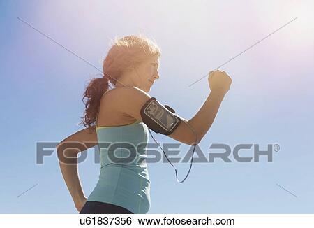Side view of young woman power walking View Large Photo Image Stock Photograph - Side view of young woman power walking. Fotosearch