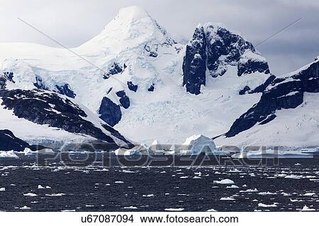 Snowcapped rock and ice floes View Large Photo Image Picture - Snowcapped rock and ice floes. Fotosearch