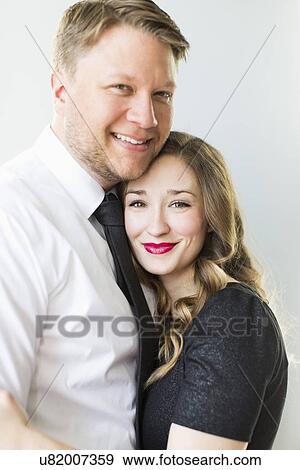 Stock Photo - Studio portrait of young couple smiling. Fotosearch