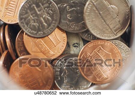 Studio shot of jar filled with coins and one dollar banknote, close up View Large Photo Image Stock Image - Studio shot of jar filled with coins and one dollar banknote, close up. Fotosearch