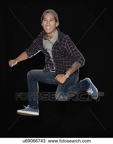 Stock Image - Studio shot of man jumping. Fotosearch