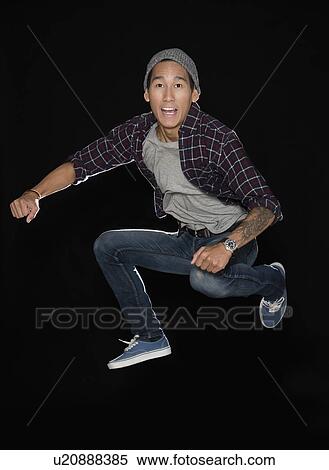 Stock Photography - Studio shot of man jumping. Fotosearch