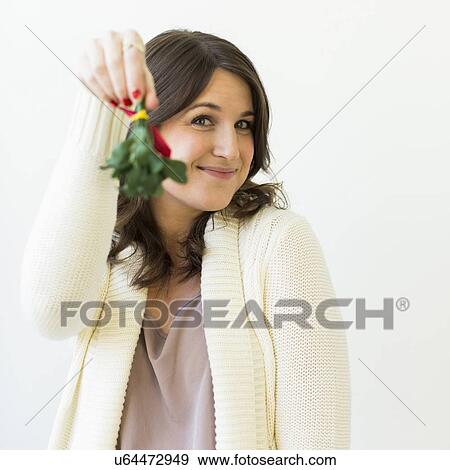 Studio shot of woman holding Christmas wreath View Large Photo Image Stock Photo - Studio shot of woman holding Christmas wreath. Fotosearch