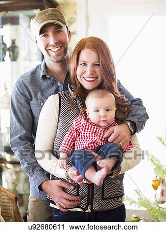 Stock Image - Studio shot portrait of family with one child (2-5 months). Fotosearch