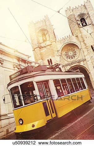 Stock Image - Tram in front of Lisbon Cathedral. Fotosearch